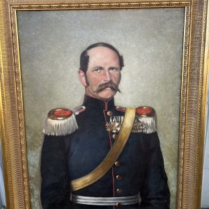 Framed portrait of a man in military uniform.